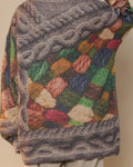 Back of the yarn patchwork sweater showing the cable and the multicolor yarn panel
