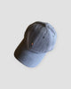 Blue gray baseball cap with a tiny embroidered yoga figure, three-quarter view
