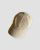 Khaki baseball cap with a tiny embroidered yoga figure, three-quarter view