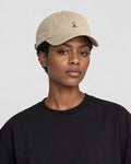Model wearing the khaki yoga embroidered baseball cap with a black tee, side view