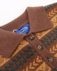Close-up of the brown polo collar, buttons and blue neck label