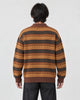 Model wearing the zigzag stripe knit polo sweater, back view