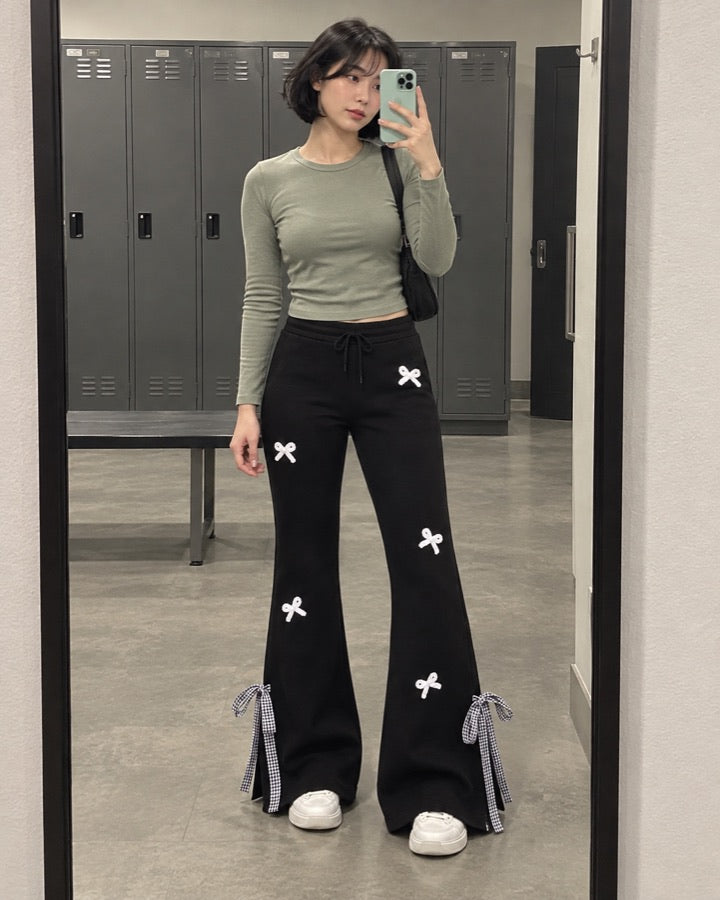 Women's Flared Sweatpants with White Bows and Gingham Slit Hems styled for an everyday setting.