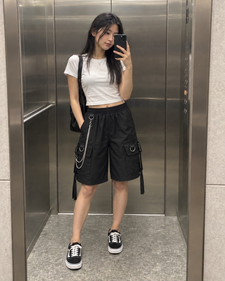 Women's Cargo Shorts with Silver Chain and Buckled Strap Pockets styled for an everyday setting.